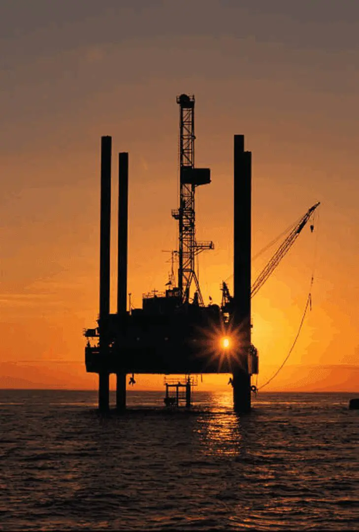 Oil platform against a colorful sunset